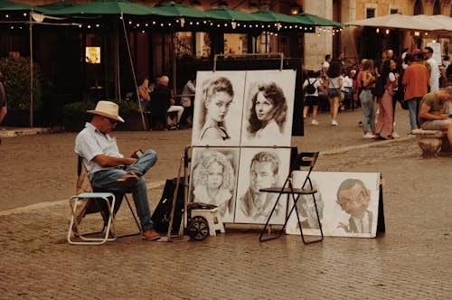A Man Selling Portraits at a Street in Rome