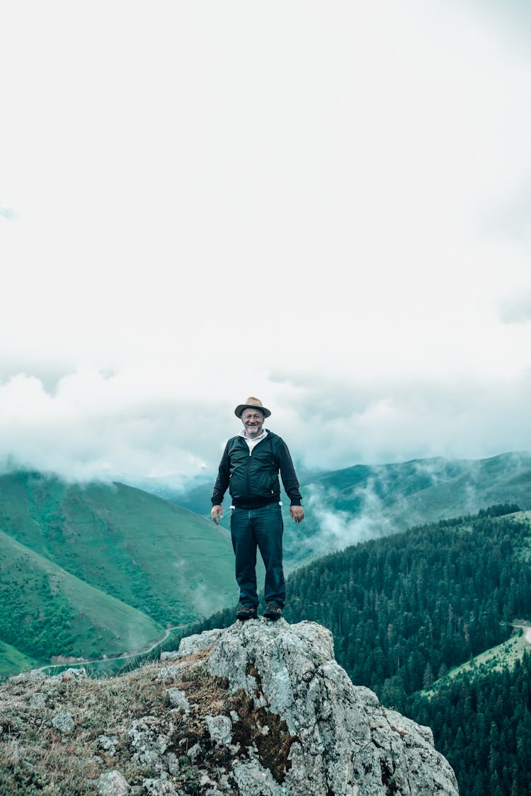 Old Man Standing On Mountain Peak