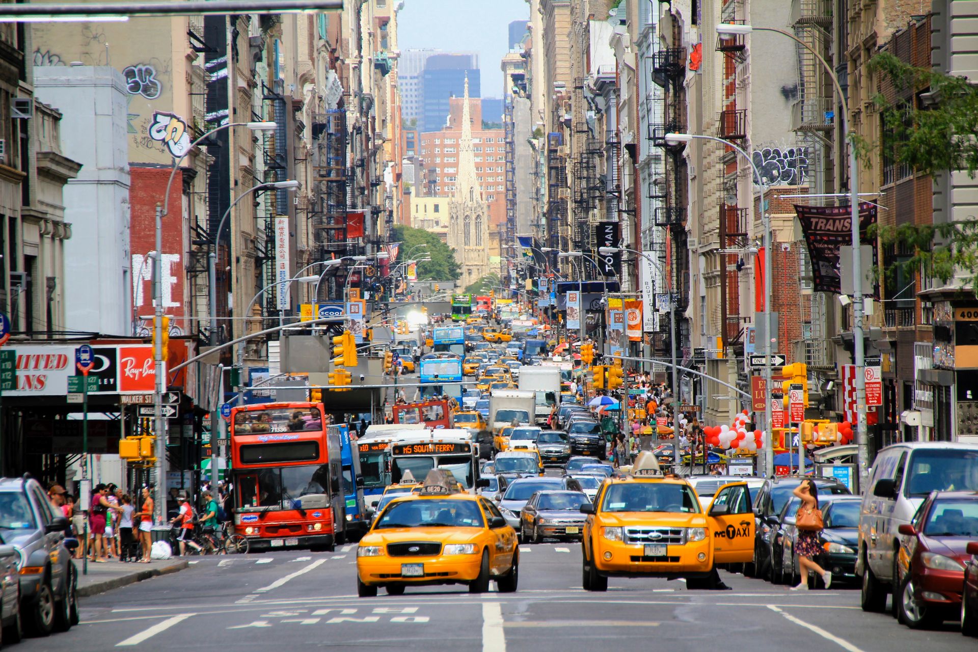 Yellow cabs and storefronts on a busy Manhattan street