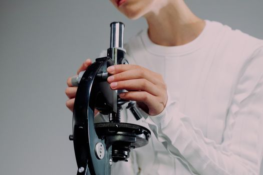 Scientist carefully using a microscope for research, close-up shot.