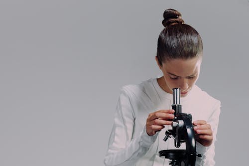 Portrait of woman using microscope