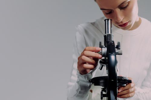 Free Woman using microscope Stock Photo