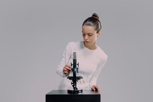 Portrait of woman looking at microscope