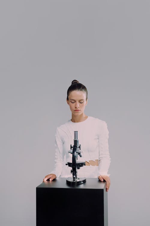 Portrait of woman standing by laboratory equipment