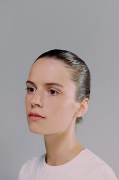 Elegant portrait of a woman looking away, captured in a studio setting on a white background.