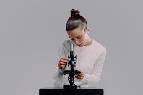 Woman looking at microscope