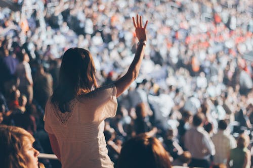 Woman With White Shirt Raising Her Right Hand