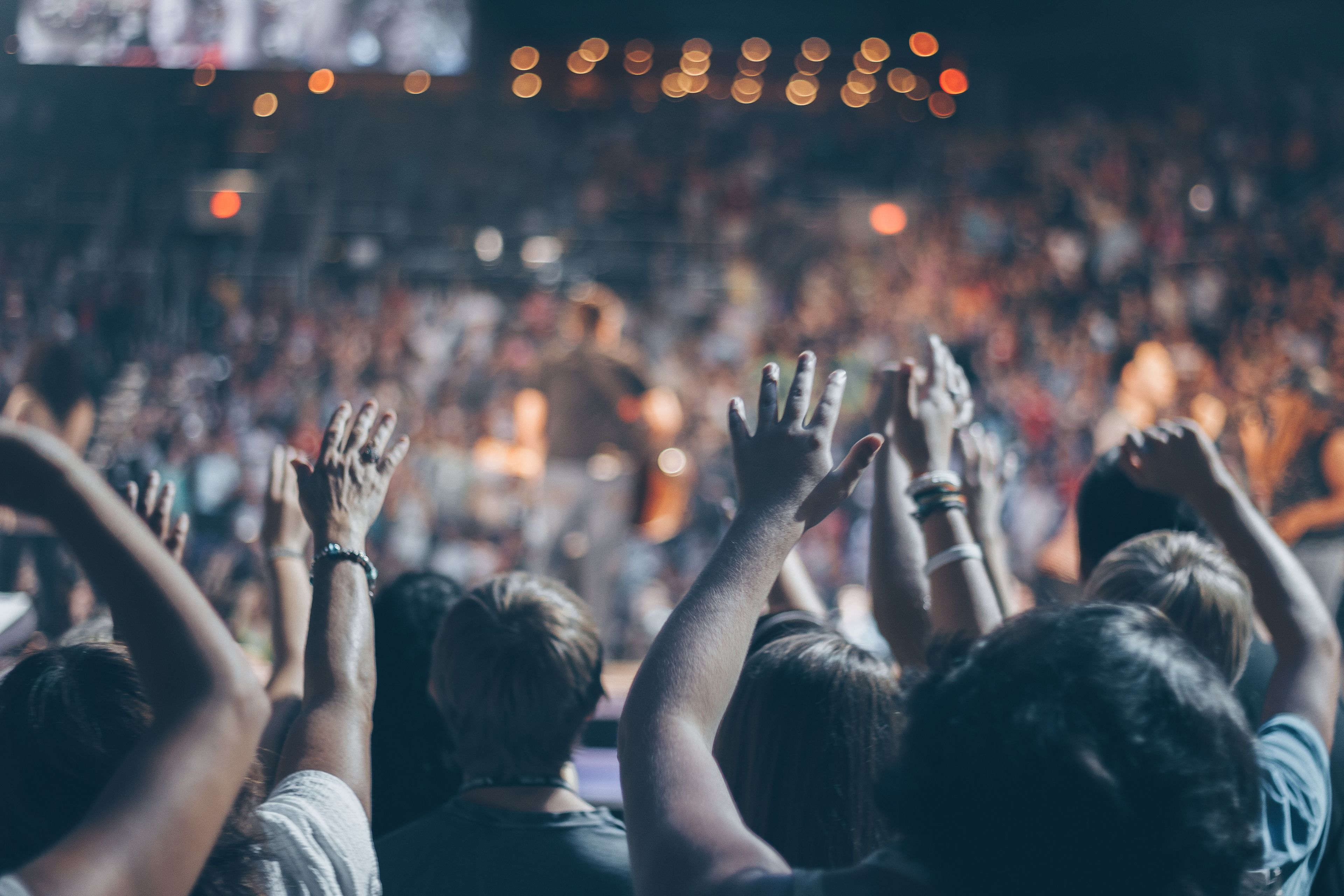 Hands raised in worship at an evening service