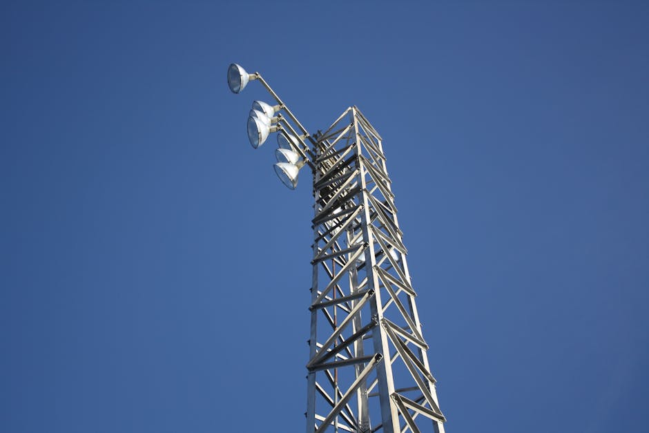 Steel communication tower extending into clear blue sky, symbolizing modern technology.