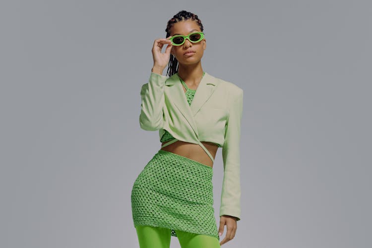 Waist Up Studio Portrait Of Woman In Green Clothes