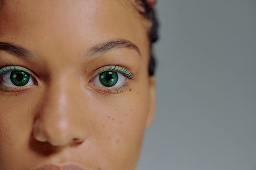 A captivating close-up image of a woman with striking green eyes, highlighting her natural beauty.