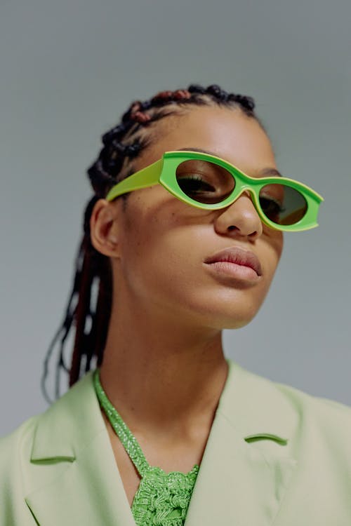 Headshot of woman with green sunglasses