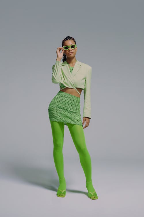 Full length portrait of woman in green sunglasses