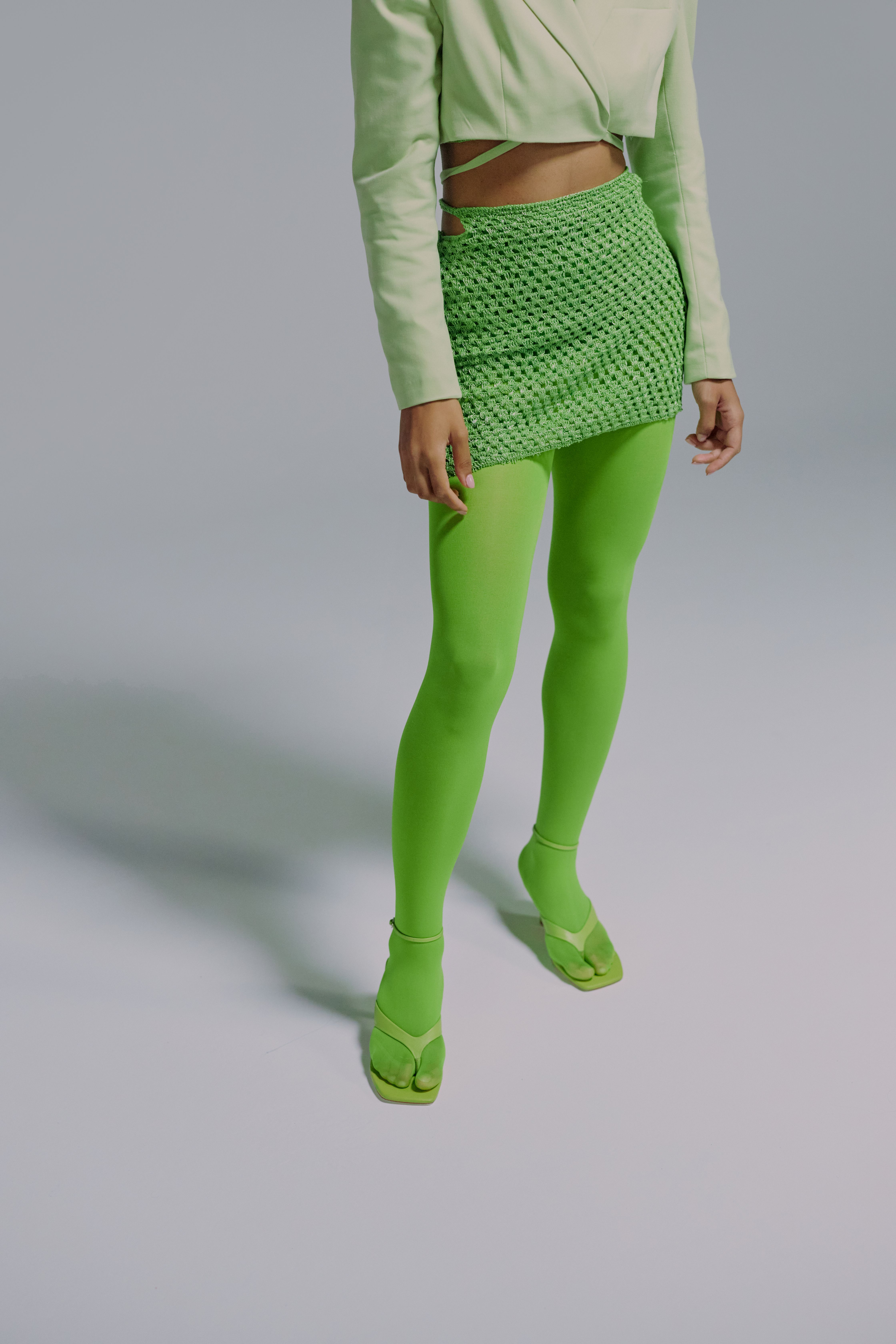 Midsection of woman in green jacket and skirt · Free Stock Photo
