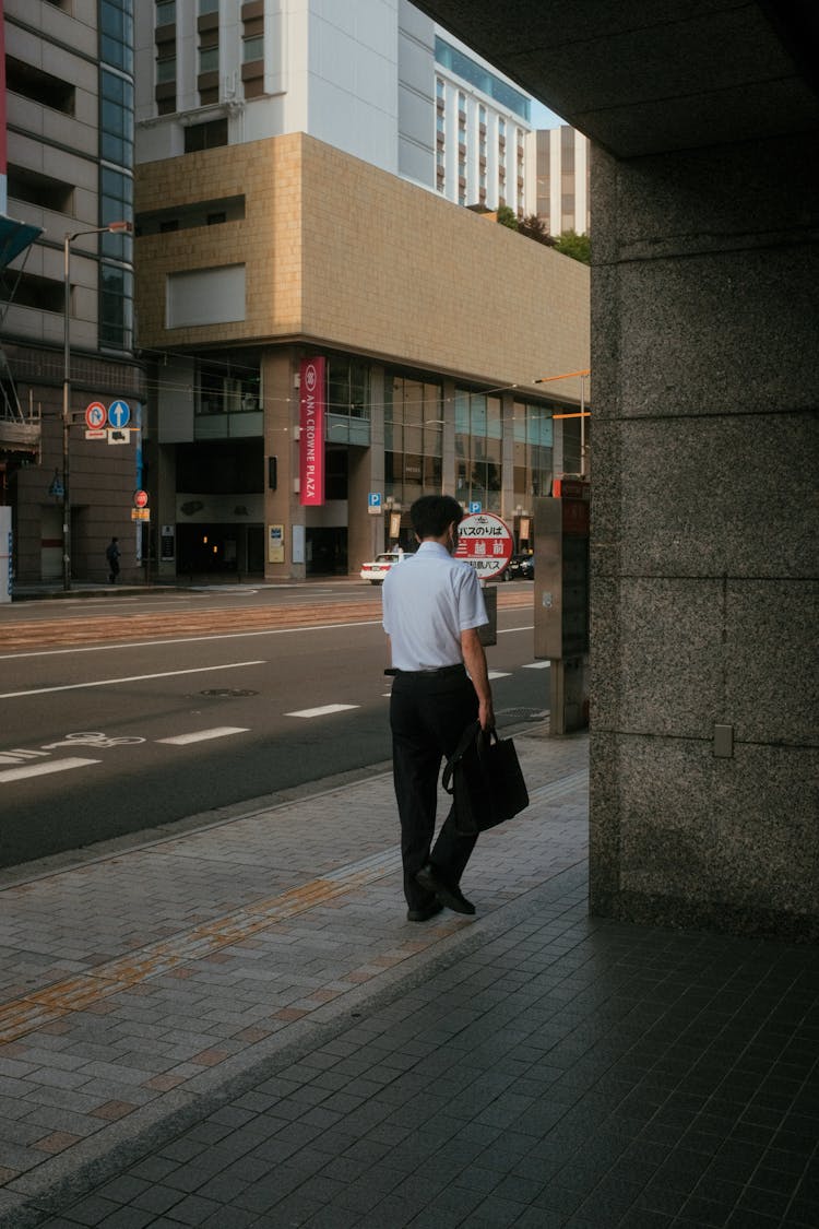 Civilian Walking On A Sidewalk 