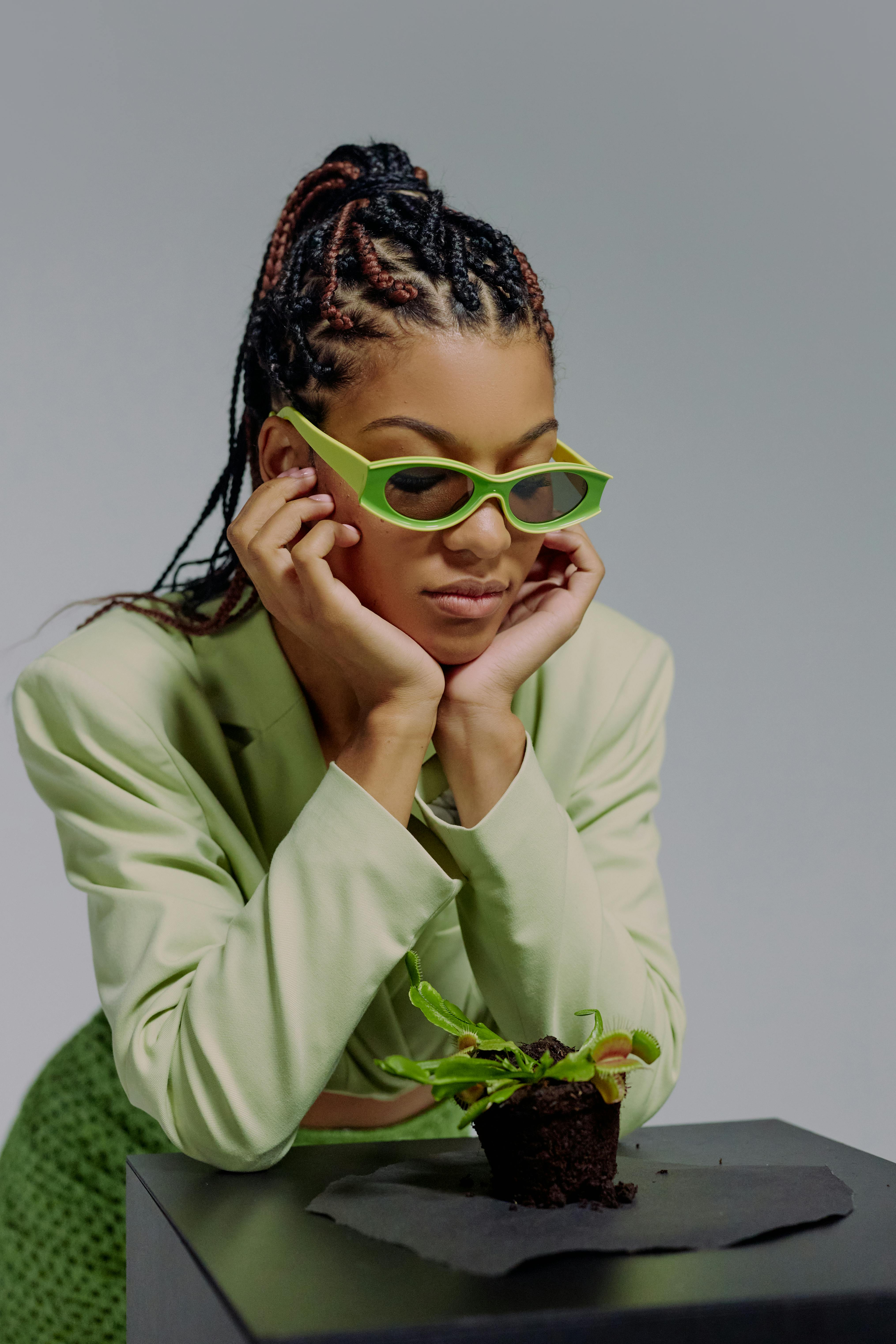 woman in green sunglasses looking at venus flytrap