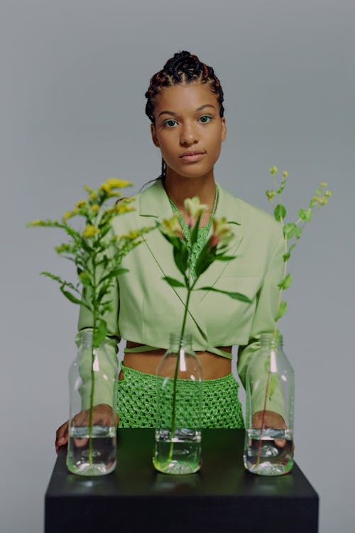 Flowers in vases in front of woman