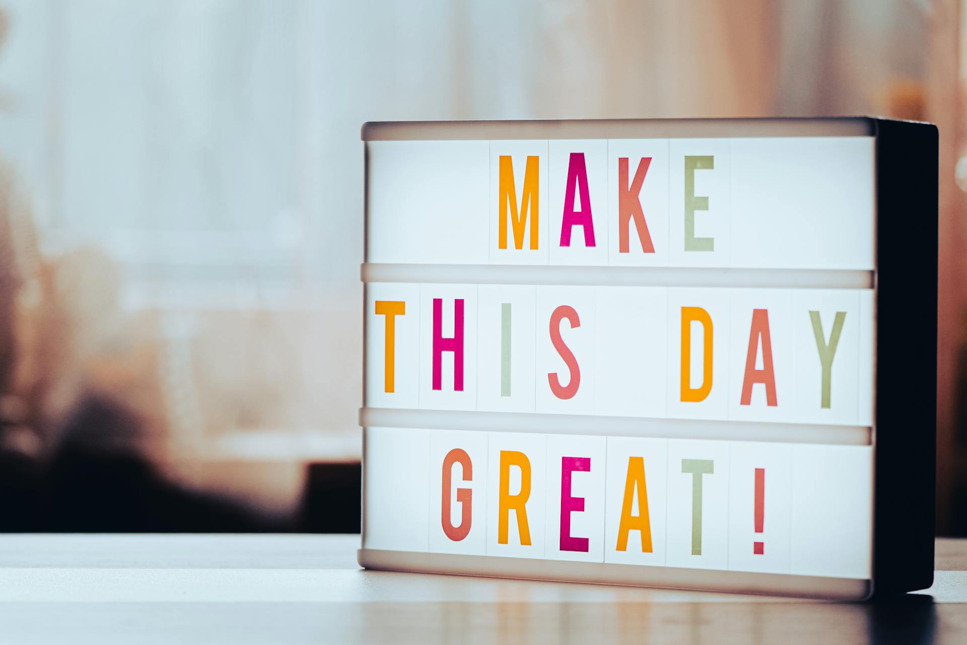 Lightbox displaying motivational message 'Make This Day Great!' in colorful letters against a blurred background.