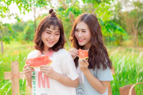 Happy Young Women with Vibrant Makeup Holding Watermelon Slices