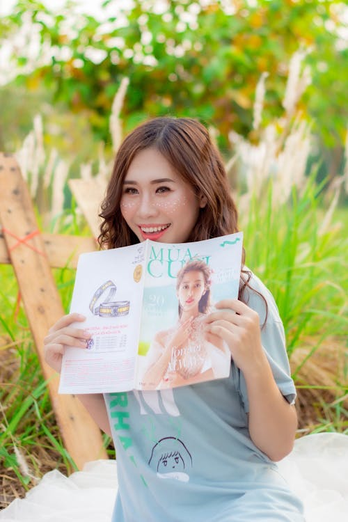 Beautiful Woman holding a Magazine 