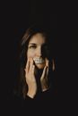 Woman holding a paper with freedom on a mouth on the black background
