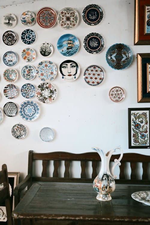 Assorted Antique Plates mounted on a White Wall 