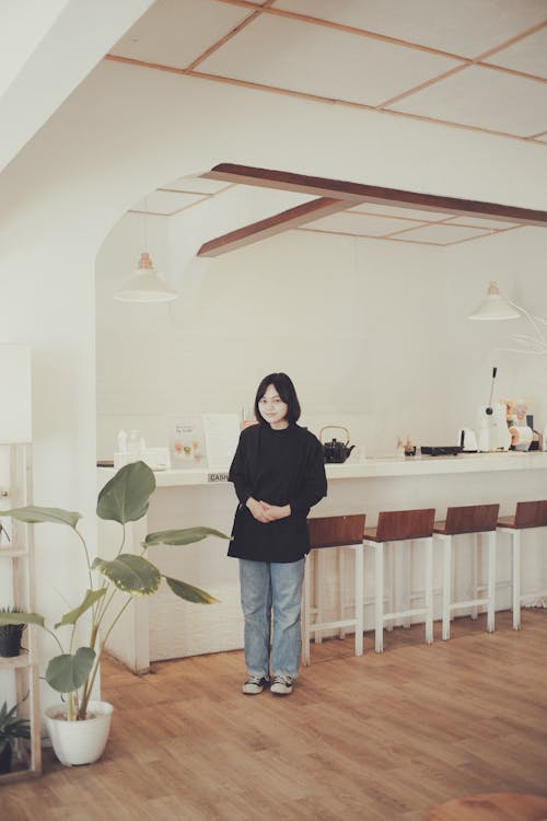 A Young Woman Standing in a Coffee Shop