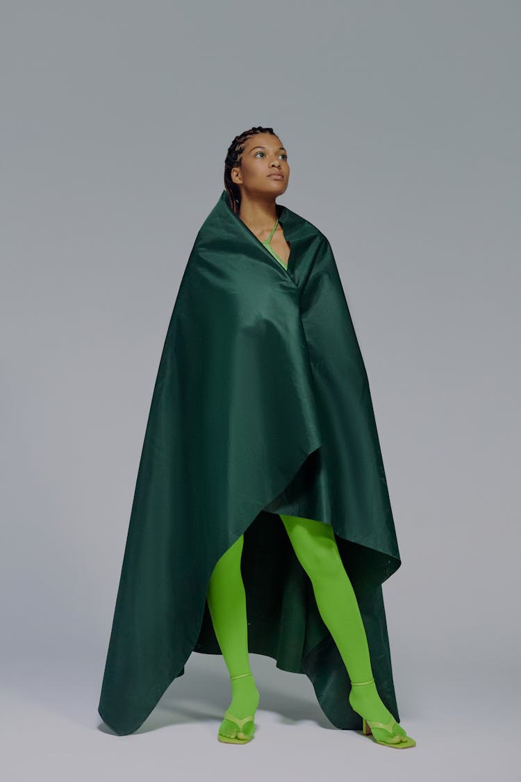 Full Length Portrait Of Woman In Green Cape