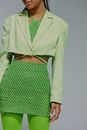 Midsection of woman in green jacket and skirt