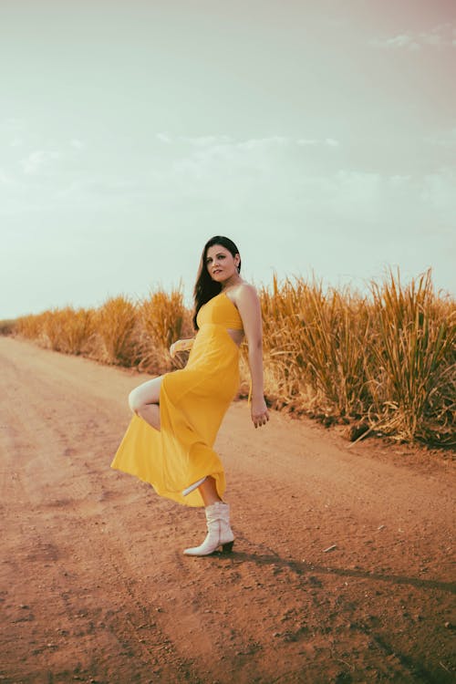 A Woman Posing in a Yellow Dress