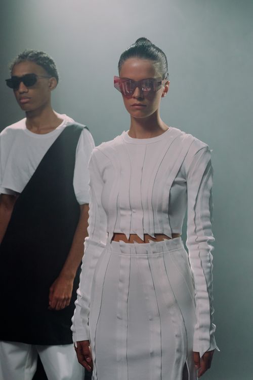 Free Stylish individuals modeling futuristic fashion in a studio setting. Stock Photo