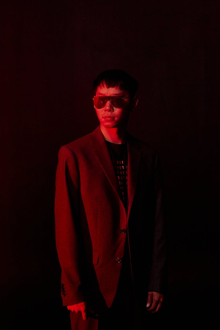 Portrait Of Man In Sunglasses Lit In Red