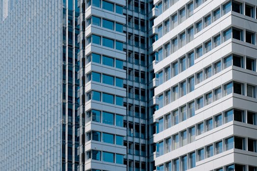 Sleek modern high-rise building with glass windows and geometric design.