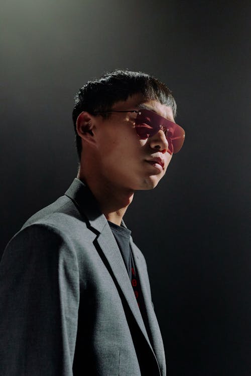 Studio portrait of man in suit and sunglasses