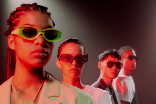 Free A diverse group of adults wearing sunglasses in dramatic red lighting. Stock Photo