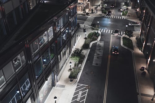 Free Cars on Road Near Buildings during Night Time Stock Photo
