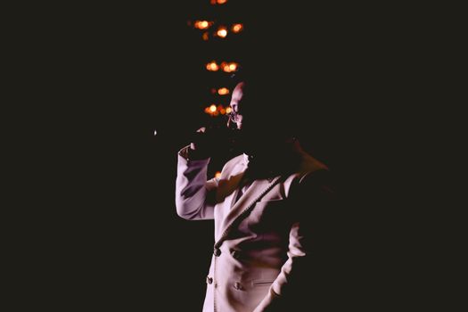 A captivating silhouette of a singer on stage with dramatic lighting and ambiance.