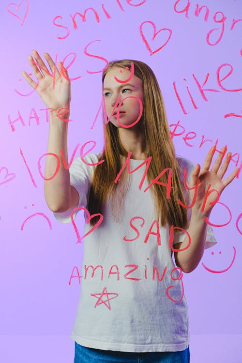 Teenage girl touching glass with words