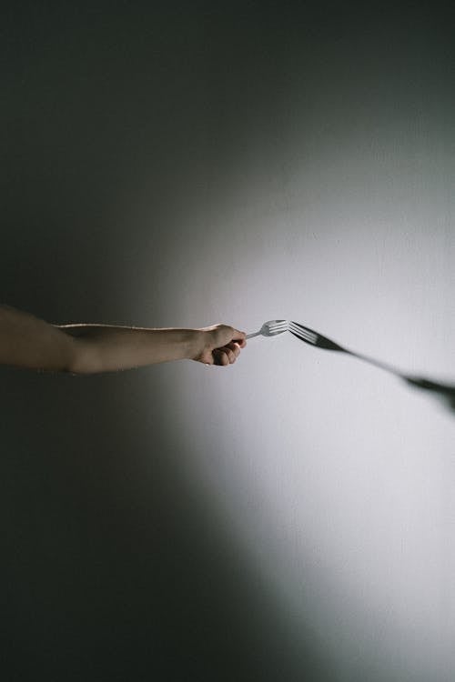 Free Person touching wall with fork Stock Photo