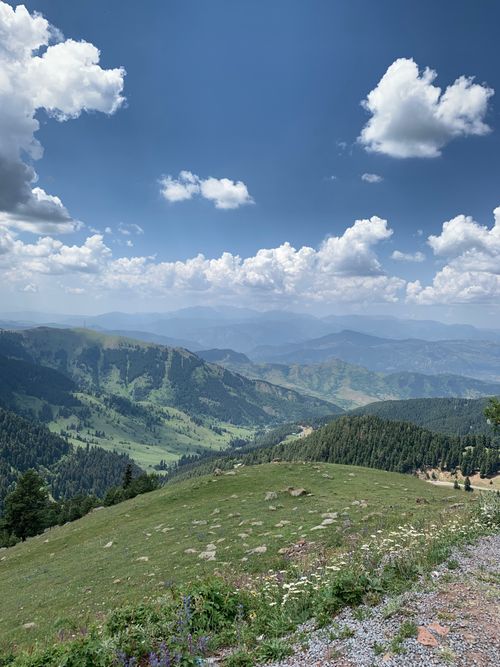 Free Stunning view of rolling hills and cloudy blue sky, perfect for nature and travel themes. Stock Photo