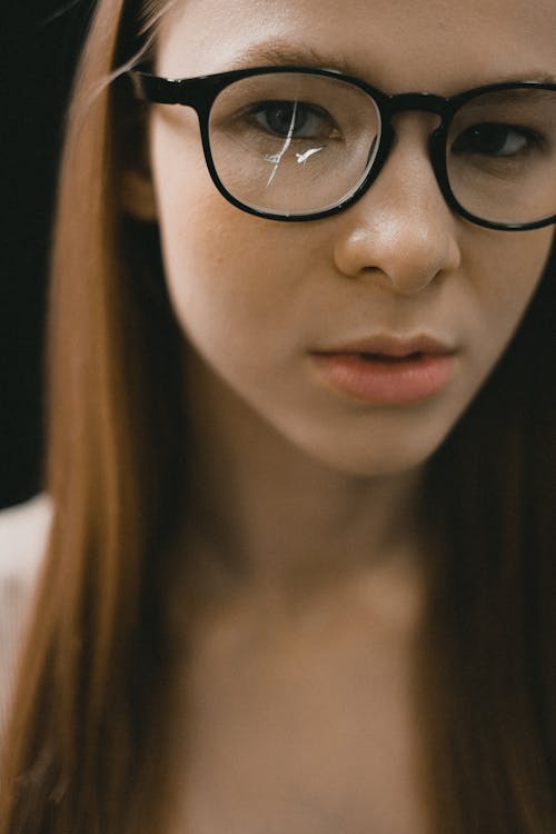 Woman wearing broken glasses