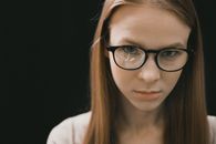 Woman in broken glasses