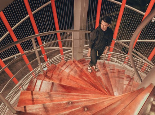 Man Wearing Black Hoodie Standing on Staircase