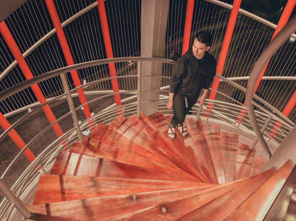 Man Wearing Black Hoodie Standing on Staircase