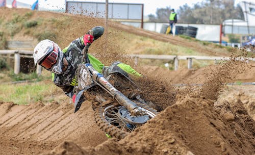 Man Riding Motocross Dirt Bike on Dirt Road