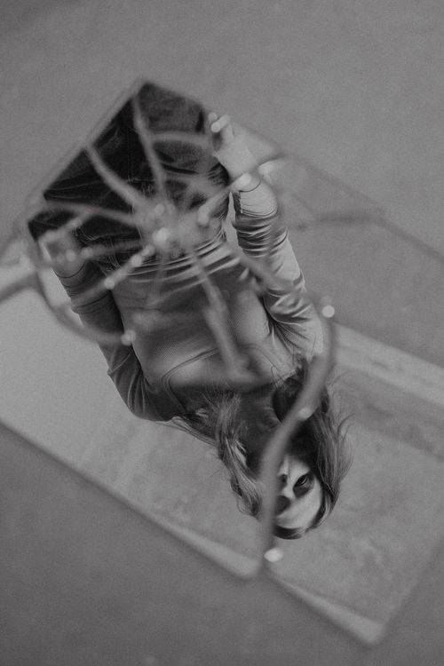 Free Artistic black and white photo of woman reflected in a cracked mirror for dramatic effect. Stock Photo