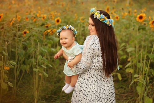 anne ve kızı, ayçiçeği tarlası, çocuk içeren Ücretsiz stok fotoğraf