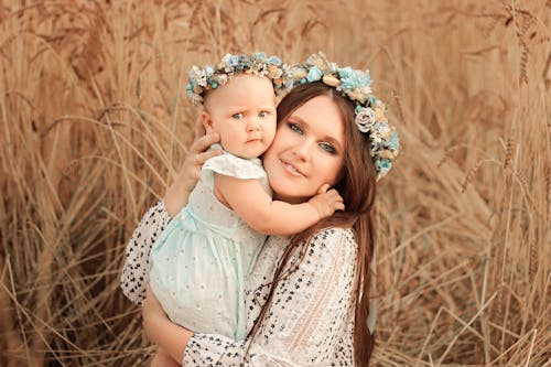 Free Mother and Daughter Sitting Beside Brown Grass Stock Photo