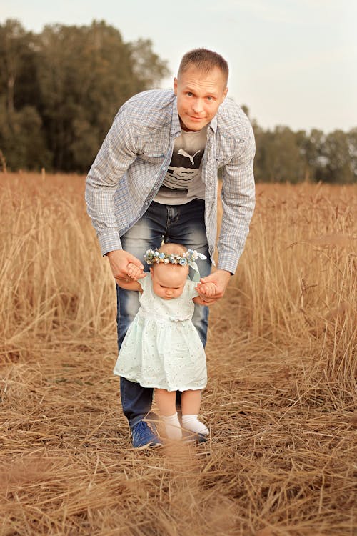 Man Walking with his Daughter in a Wheat Field