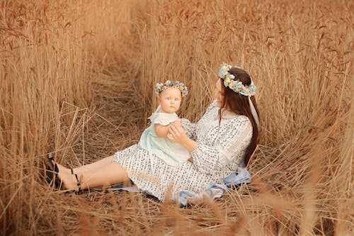 Free A Mother and Baby on a Brown Grass Field Stock Photo